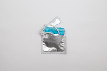 Сondom and medical mask, covid-19, coronavirus, contraception, safety, world aids day