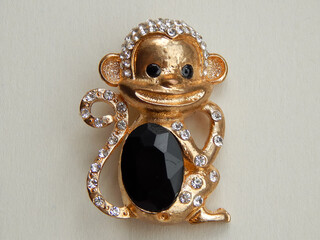   gold brooch in the form of a monkey                                                            