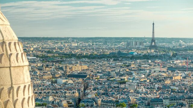 Panorama of Paris aerial timelapse with Eiffel tower, France. Top view from Sacred Heart Basilica of Montmartre (Sacre-Coeur). Sunny day with blue cloudy sky.