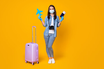 Full length body size view of nice slim healthy girl wearing safety mask holding in hands paper plane passport disease prevention isolated bright vivid shine vibrant yellow color background