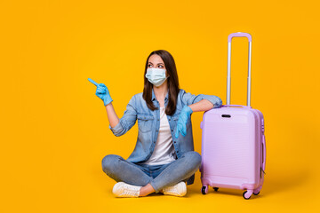 Portrait of her she nice attractive girl sit crossed legs wearing safety mask departure showing copy space stop pandemia infection isolated bright vivid shine vibrant yellow color background