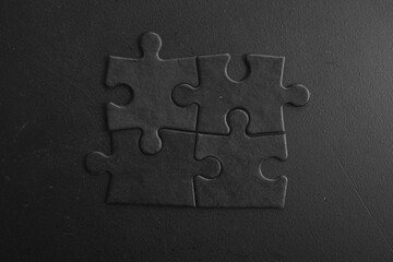 Photo of black puzzles on a black background, business background