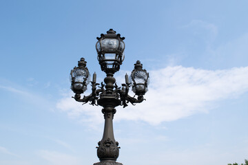 Fototapeta na wymiar old street lamp with blue sky The Pont Alexandre III