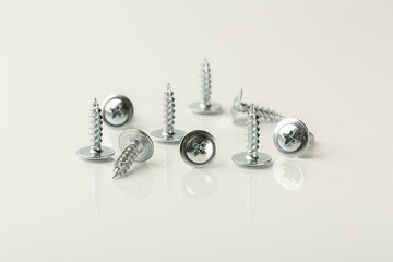 Screws of different lengths on a white background