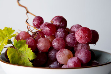 still life of red grapes on white wooden table