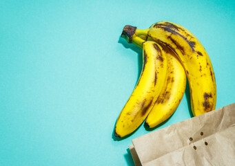 Ripe bananas with paper bag isolated. Supermarket online shopping. Shopping delivery.