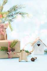 Festive Xmas decorations, homemade gift, fir branches on blue background.