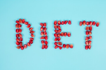 DIET arrangement of fruit; Pomegranate seeds on blue background. weight loss, nutrition, Healthy food, Intermittent fasting and vegetarian concept