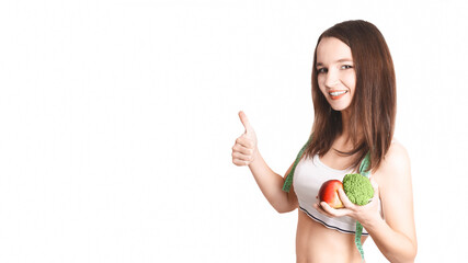 caucasian girl.Weight loss, slim body, diet, sport, fitness and health concept. young beautiful woman holding broccoli and apple with a tape measure shows gesture class. white background. copy space