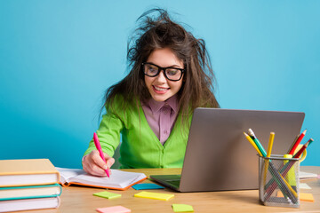 Close-up portrait of nice attractive intelligent cheery focused brunette girl doing homework using...