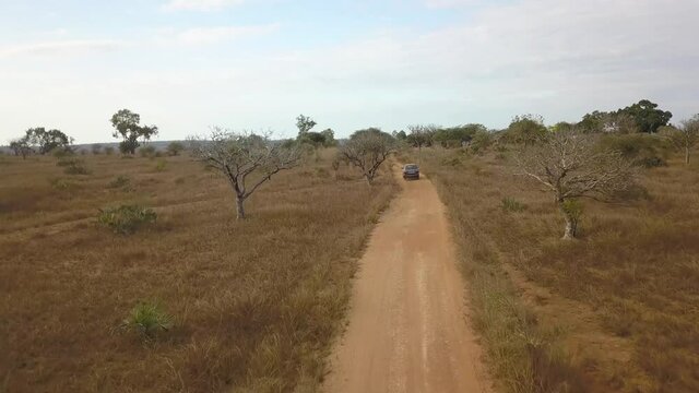 Aerial Follow Shot Of A Truck Driving On Dusty African Road, Madagascar