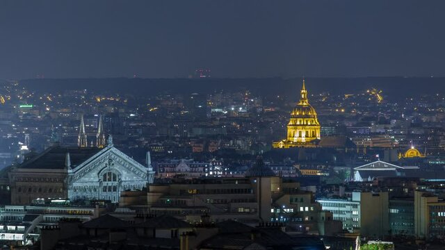 Paris night cityscape timelapse seen from Montmartre with Garnier opera and Les Invalides. Top view from viewpoint. Paris, France