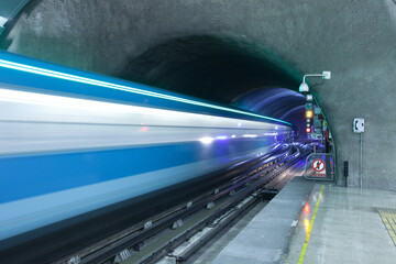 Motion blur of a train coming out of subway tunnel at Metro de Santiago