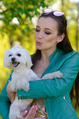Puppy white dog with it's owner. Concept about friendship, animal and freedom.