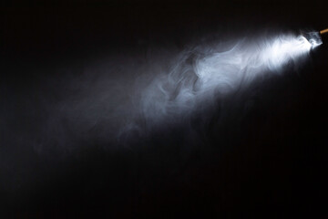 spotlight, ray of light on smoke. black backround