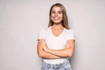 Young woman with crossed arms, isolated on white background