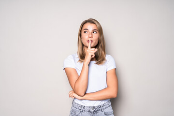 Secret woman showing hand silence sign isolated on white background