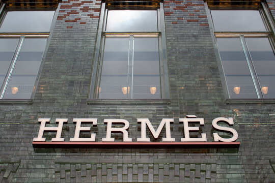 View of facade (made with glass bricks) of French fashion goods manufacturer's store on luxury shopping street named "Pieter Corneliszoon Hooft" in Amsterdam. It is a summer day.