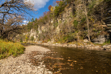 Root River In Autumn - A scenic river next to a cliff.