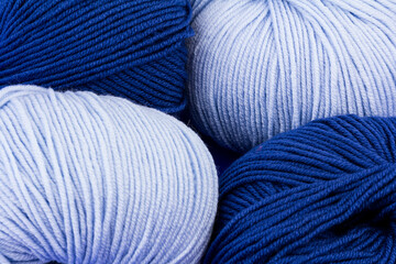 woolen merinos blue threads on blue background. natural wool. knitting. background