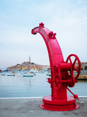 Vintage crane in red at the port of Rovinj in Croatia