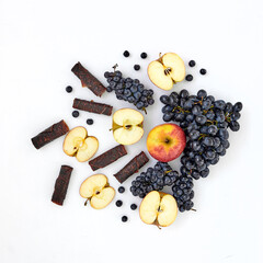 Summer composition with pastilles, apples and grapes on a white background.