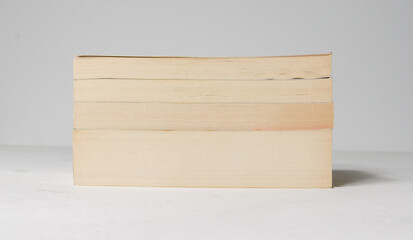 A pile of old books with old browning pages stacked on top of each other. old reading books, knowledge and information in a physical form.