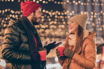 Photo of positive couple hold eggnog beverage mug speak under evening x-mas christmas tradition...