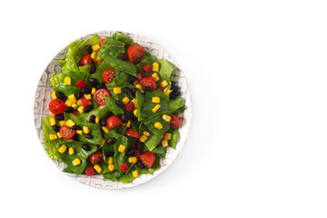 Mexican salad with black beans, corn,tomatoes,lettuce and pepper isolated on white background. Top view. Copy space