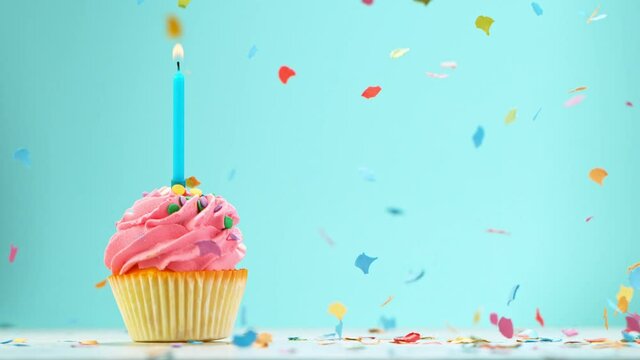 Birthday Cake With Burning Colorful Candle on Pastel Blue Background. Super Slow Motion, 1000 FPS.