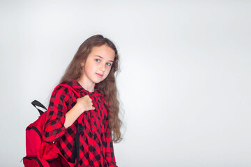 Cute little girl wearing red backpack standing on white background ,place for text, back to school concept