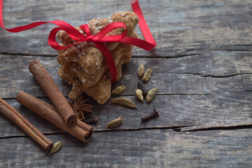Christmas gingerbread cookies, cinnamon, anise and clove spice on chalkboard background with space for text