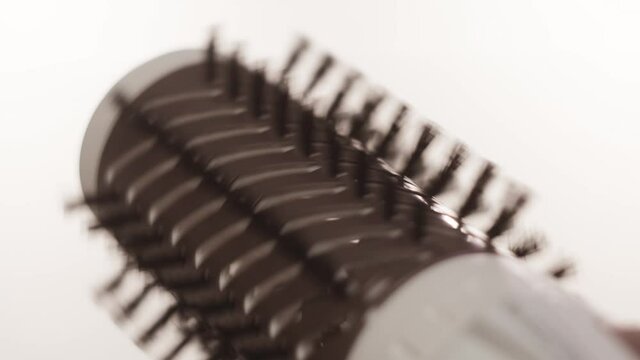 Rotating brush on hair dryer. Concept. Close-up brush with bristles for Curling and drying hair. Hair dryer Curling brush on white isolated background