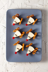Funny christmas snack in a shapes of deer for kids party. Concept New year food from cheese and pretzels