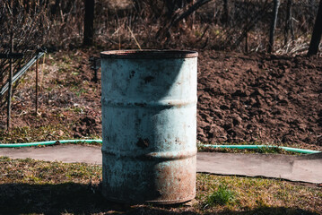 Old wooden barrel standing in a corner of an old house to collect water