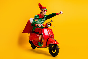 Portrait of his he nice attractive cheerful energetic funny guy elf riding moped bringing fast...