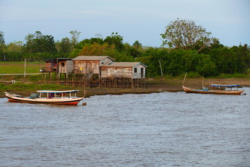 Tropical Amazon landscape shortly before sunset, idyllic villages of small farmers and fishermen on...