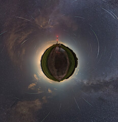 360 degrees panorama little planet, a man standing on the road looks at the reflection in the water...
