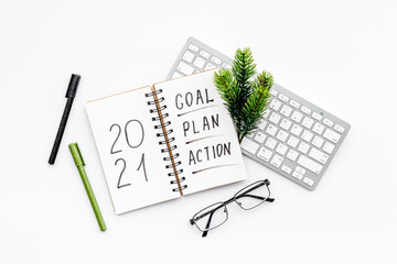 Inspiration concept - New Years goals written in notebook on a table, flat lay