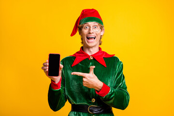 Portrait of his he nice attractive amazed glad cheerful cheery funny guy elf holding in hands...