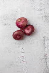 Top View of Red Cipollini Onions on a Cement Background