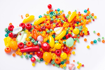Lot of different glass beads, seed beads on white background