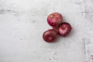 Top View of Red Cipollini Onions on a Cement Background