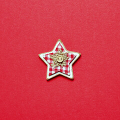 Wooden Christmas star ornament on red background. New Year Christmas minimal greeting card background. Flat lay.