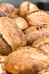 Various rustic bread on a wooden board. Healthy food and farming concept