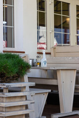 Sanitizer in bottle with spray on the table in cafe or restaurant outside. Antiseptic, hygiene and healthcare concept. New normal lifestyle rules. Preventing the spread of Coronavirus (Covid-19).