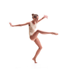 young beautiful dancer in beige swimsuit posing - 388998773