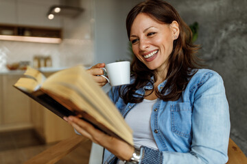 Reading book while drinking coffee.