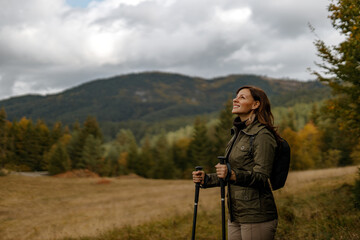 Standing in nature, alone.