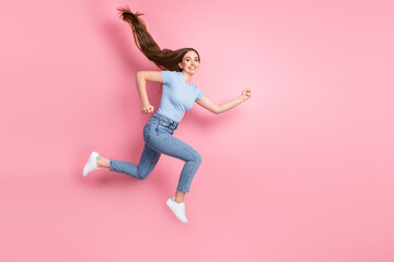 Fototapeta na wymiar Photo portrait of rushing girl jumping up isolated on pastel pink colored background